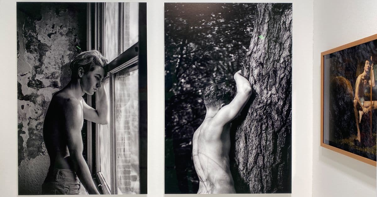 Three fine art photography works by Arjan Spannenburg displayed at PAN Amsterdam. From left to right: a black-and-white portrait of a man looking out a window (Ingrained), a monochrome study of a man leaning against a tree (Revival), and a framed color portrait with religious iconography (John the Baptist)