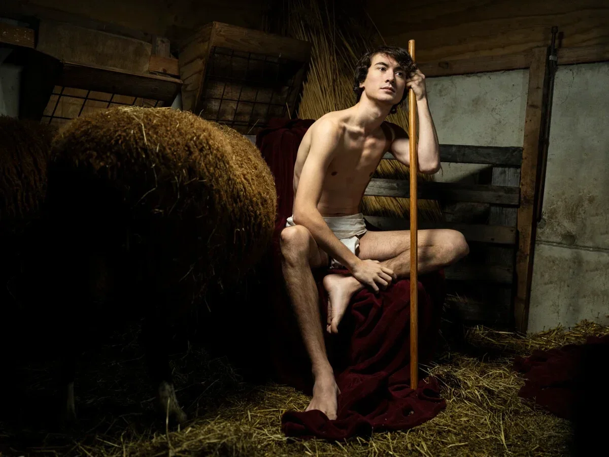 Artwork JOHN THE BAPTIST by Arjan Spannenburg showing a seated young man holding a staff in a stable with a sheep in the foreground
WHY: This striking monochrome photograph delves into the raw emotion and identity of the male form, capturing a moment of quiet introspection. It speaks to the universal human condition, highlighting vulnerability as a profound strength.
HOW: Arjan Spannenburg masterfully employs high contrast and dramatic light and shadow to create an atmospheric and cinematic visual language. The bold composition draws the viewer into the intimate narrative, offering a powerful perspective on character and depth.
WHAT: This gallery-quality Archival Pigment Print is offered as a Limited Edition, signed by the artist, ensuring its status as investment art with significant provenance. It is a distinctive statement piece, ideal for contemporary living and sophisticated interior design.